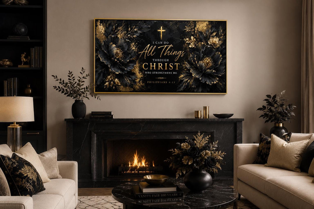 Philippians 4:13 canvas art with gold lettering and florals on black, hung above a fireplace.