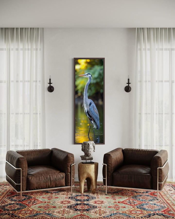 Vertical narrow wall art featuring a blue heron standing in water with soft, blurred background.