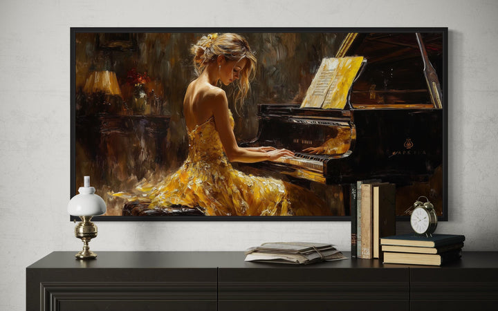 Framed canvas wall art of a woman in a yellow dress playing a grand piano in a moody room.