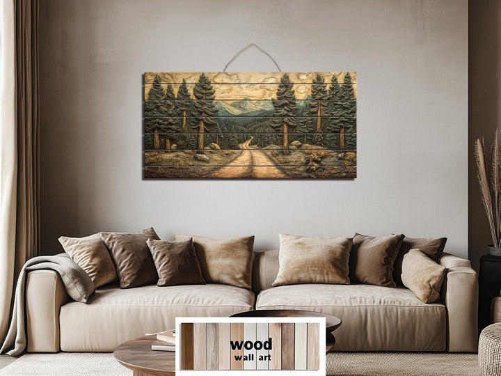 Pine forest landscape printed on a horizontal distressed wood wall art piece above a tan sofa.