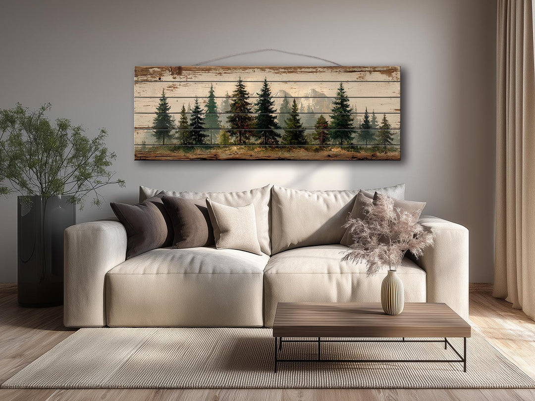 Pine forest mountain landscape rustic wood wall art displayed above a modern sofa in a living room.