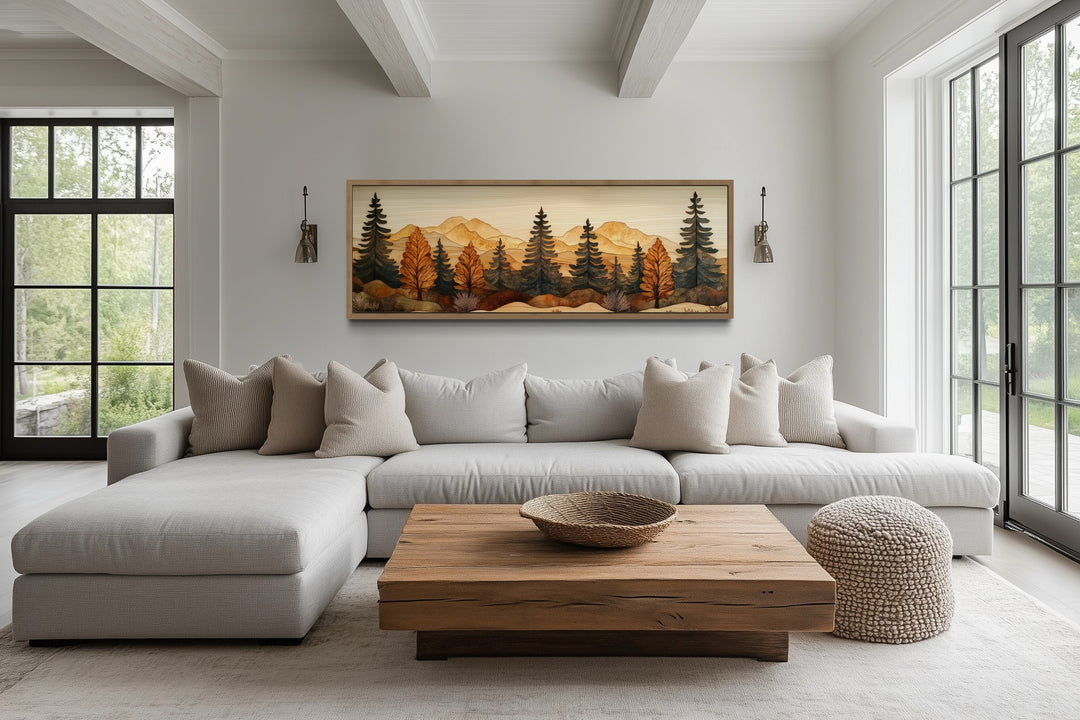 Pine forest wood mosaic painting in a long horizontal frame above a modern living room sofa.