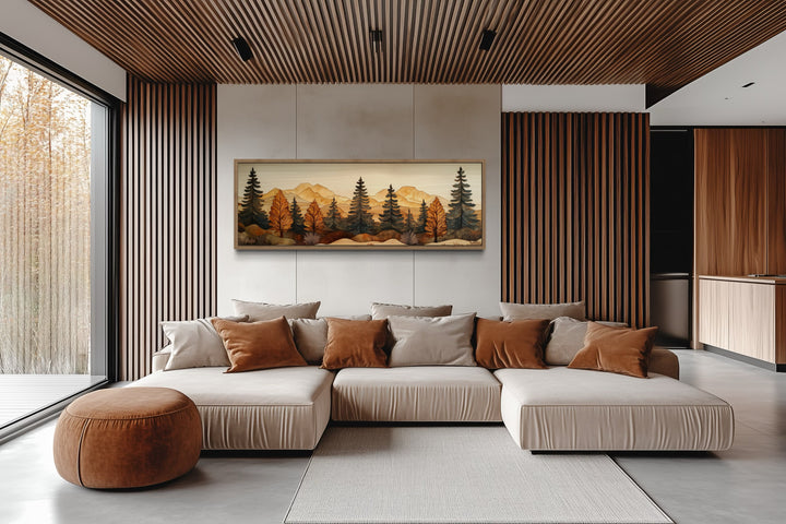 Pine forest wood mosaic painting hanging above a beige sectional sofa in a modern rustic living room.