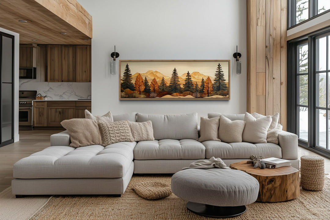 Pine forest wood mosaic wall art in a long horizontal frame hanging above a light gray sectional.