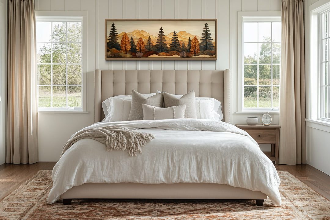 Pine forest wood mosaic painting in a long horizontal frame hanging above a bed in a bedroom.