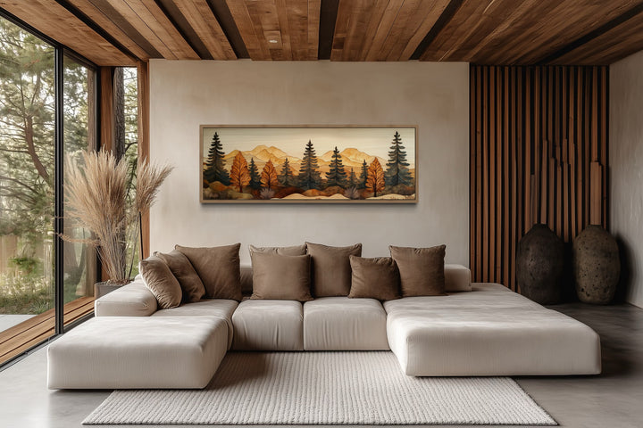 Long horizontal pine forest wood mosaic wall art hanging above a modern beige sectional sofa.