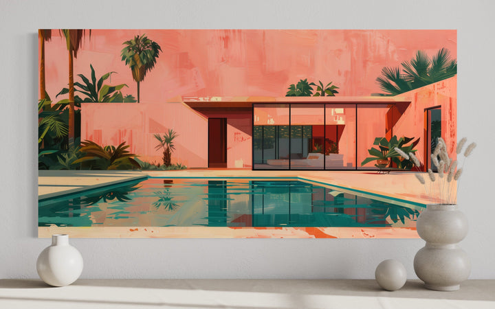 Retro mid-century modern house and pool canvas print in pink and green, displayed on a white wall.