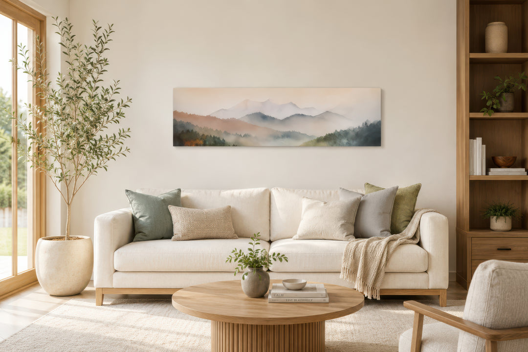 A panoramic canvas of a pastel pink and green mountain landscape hangs above a neutral sofa.