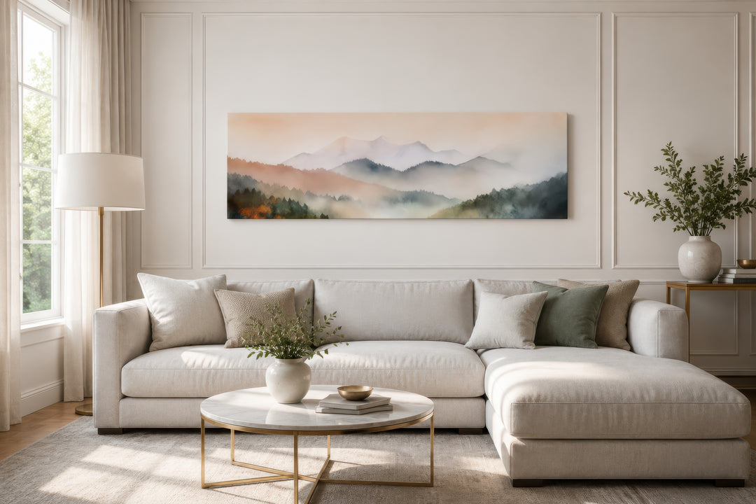 Pink and green pastel mountain landscape canvas art displayed above a neutral sectional sofa.