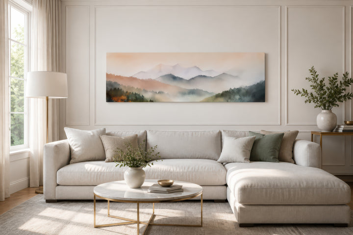 Pink and green pastel mountain landscape canvas art displayed above a neutral sectional sofa.