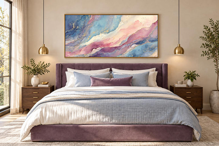 Pink and blue abstract marble framed canvas wall art hanging above a purple velvet bed.