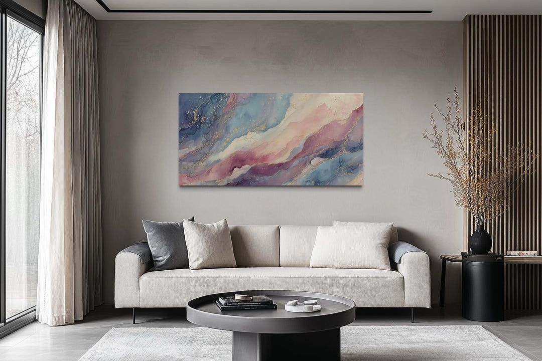 Pink and blue abstract marble framed canvas wall art hanging above a modern sofa in a living room.