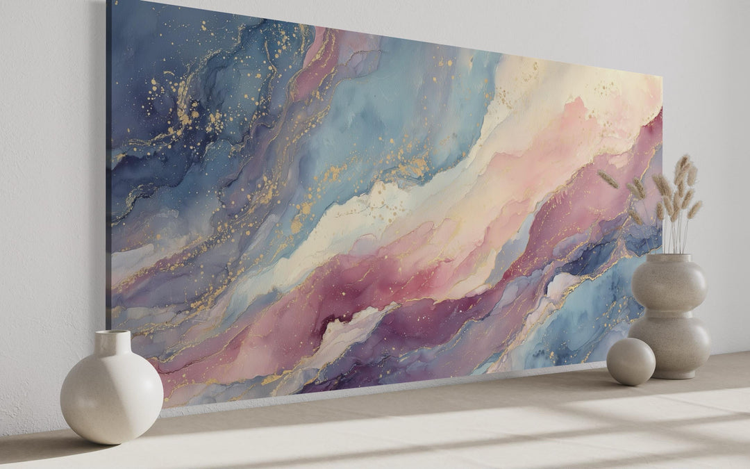 Pink and blue pastel abstract marble framed canvas wall art with gold accents in a modern room.