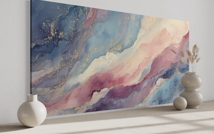 Pink and blue pastel abstract marble framed canvas wall art with gold accents in a modern room.