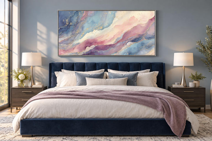 Pink and blue abstract marble framed canvas wall art above a navy velvet bed in a modern bedroom.