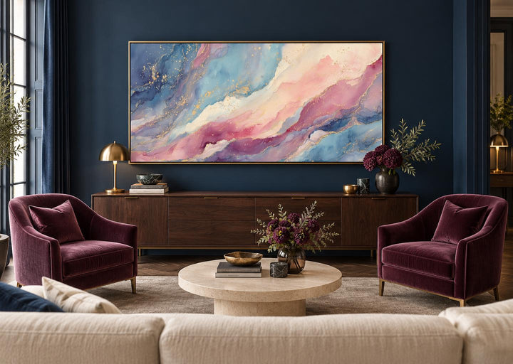 Pink and blue pastel abstract marble framed canvas wall art above a dark wood sideboard.