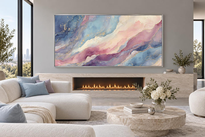 Pink and blue pastel abstract marble framed canvas wall art above a modern fireplace.