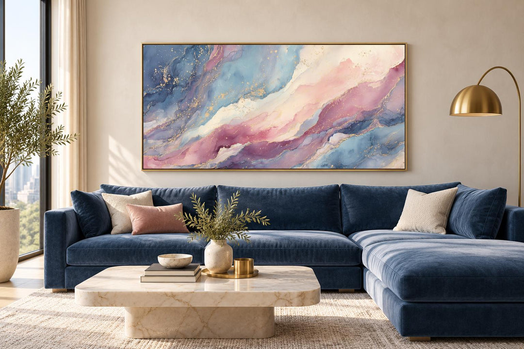 Pink and blue abstract marble framed canvas wall art above a navy sofa in a living room.
