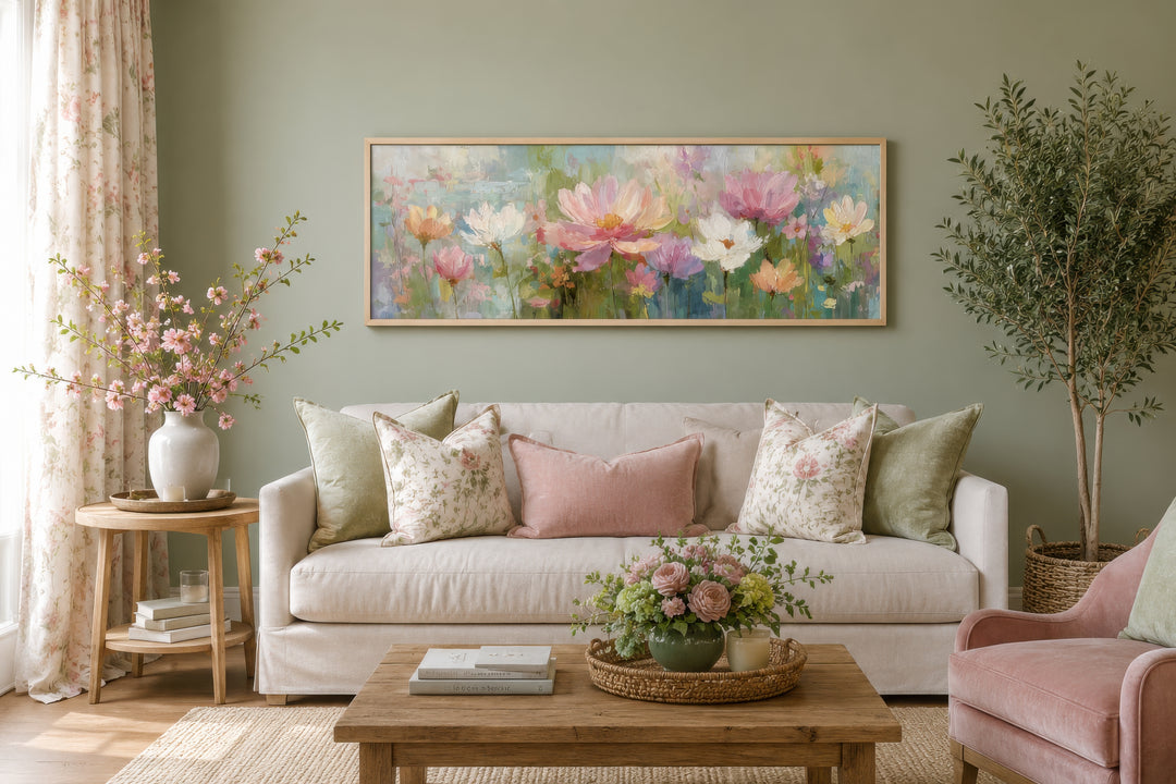 A long horizontal botanical painting featuring pink and white flowers in a light wood frame.