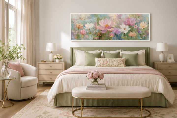 A long horizontal botanical painting with pink and green flowers hangs above a bed in a bedroom.