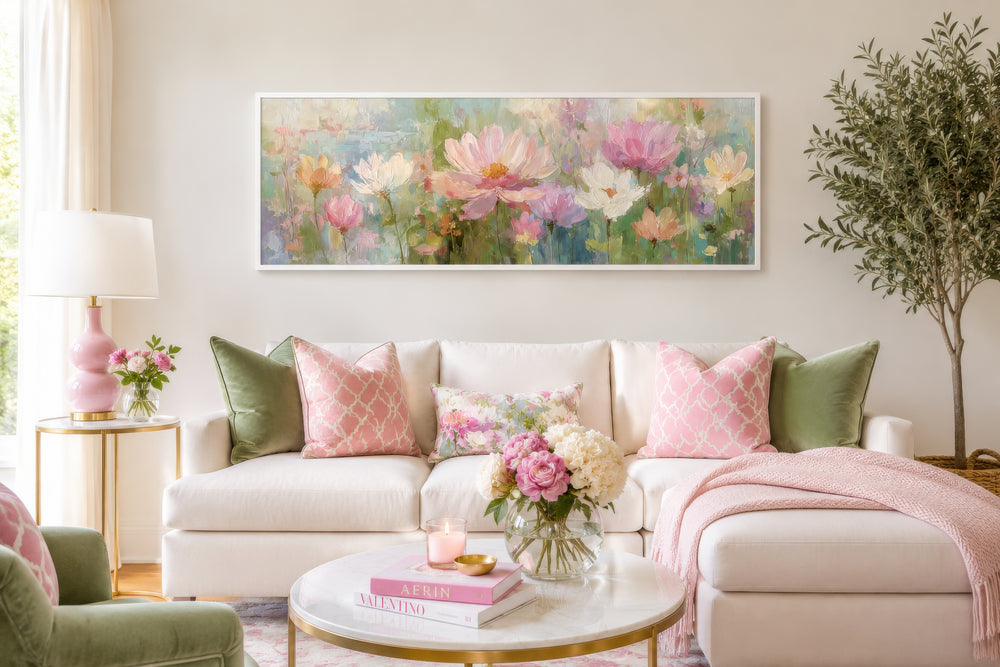 Long horizontal botanical floral wall art featuring pink and green blooms above a white sofa.