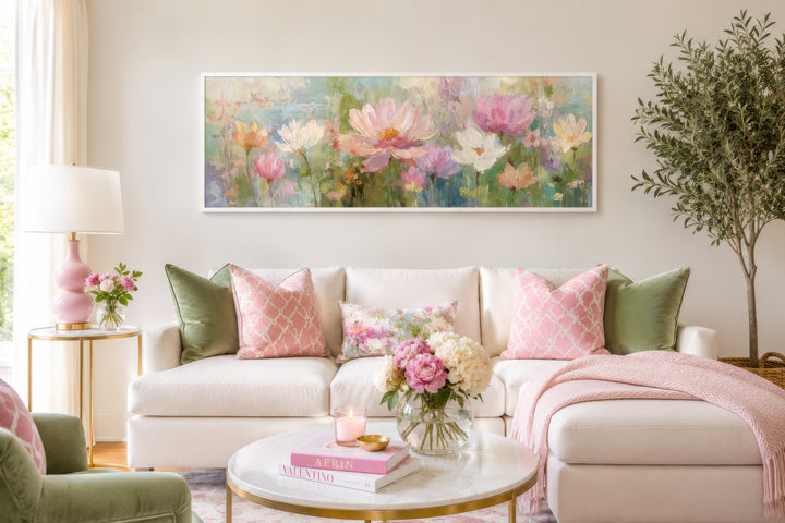 Long horizontal botanical floral wall art featuring pink and green blooms above a white sofa.