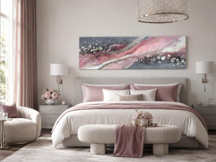 Pink and grey abstract geode canvas print hanging above a bed in a modern bedroom.