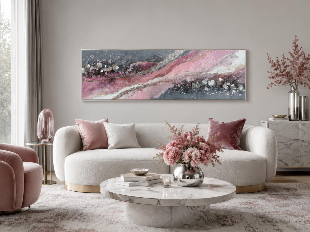 Pink and grey abstract geode canvas print in a long horizontal format above a white sofa.