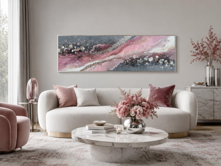 Pink and grey abstract geode canvas print in a long horizontal format above a white sofa.
