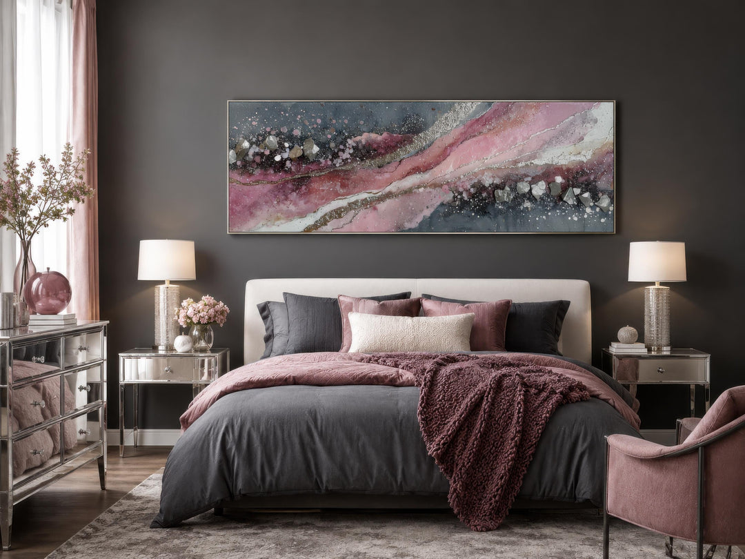 Pink and grey abstract geode canvas print above a bed in a modern bedroom.
