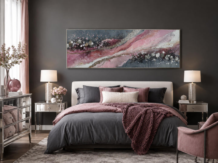 Pink and grey abstract geode canvas print above a bed in a modern bedroom.