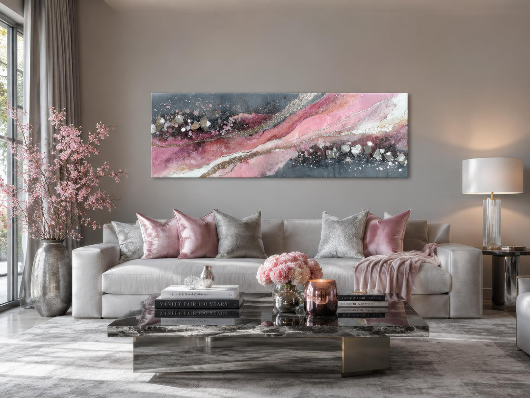 Pink and grey abstract geode canvas print hung above a light grey sofa in a modern living room.