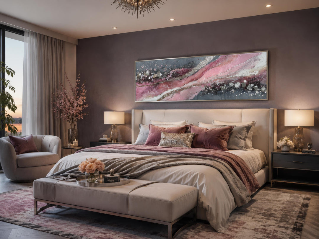 Long horizontal pink and grey abstract geode canvas print hanging above a bed in a modern bedroom.