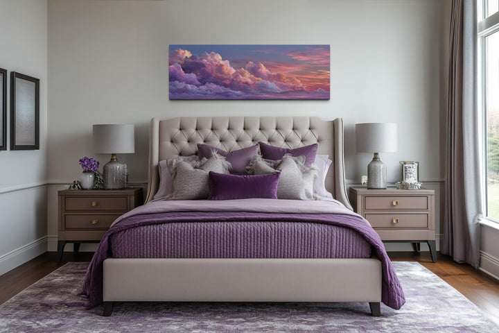 Panoramic canvas wall art featuring a dreamy pink and purple sunset sky above a tufted bed.