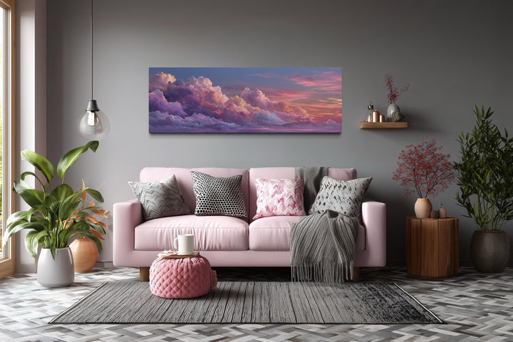 Panoramic canvas wall art featuring a dreamy pink and purple sunset sky above a modern pink sofa.