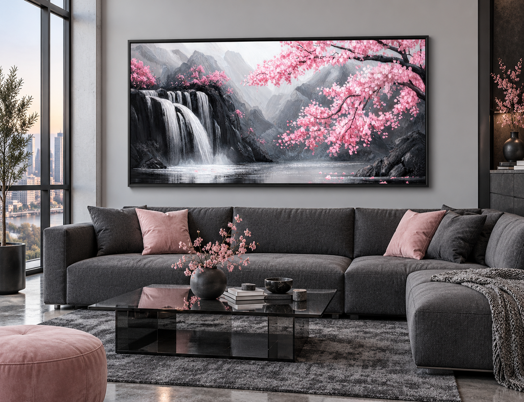 Pink cherry blossom and grey waterfall framed canvas wall art above a grey sectional sofa.