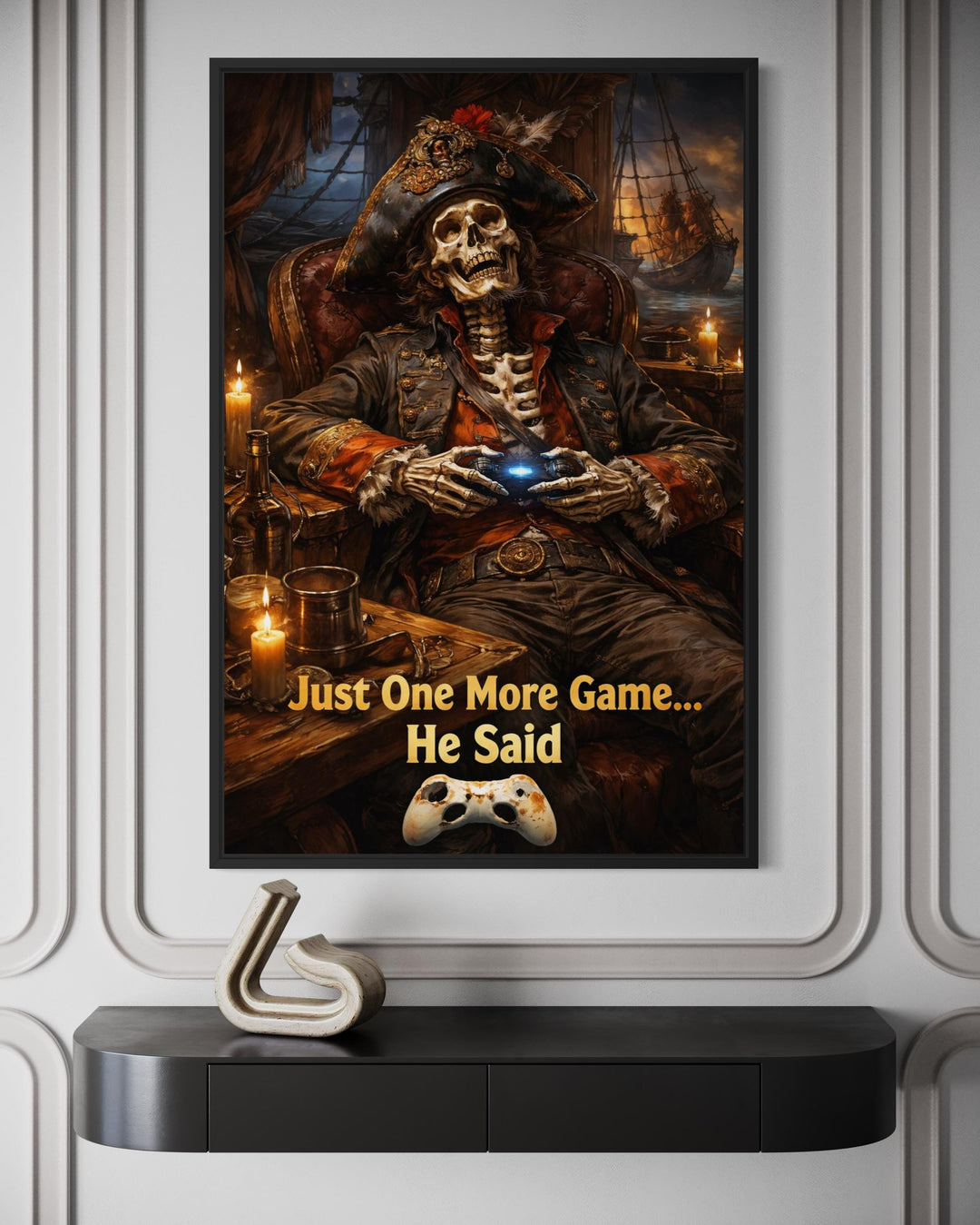 Framed pirate skeleton wall art with a gaming quote hangs above a modern black console table.