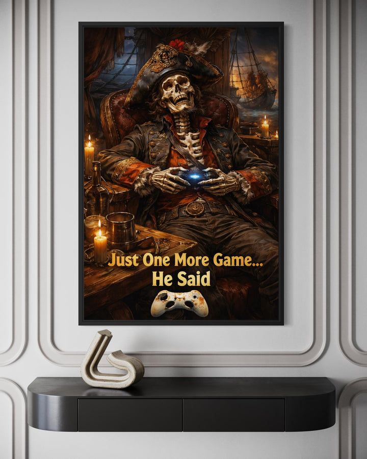 Framed pirate skeleton wall art with a gaming quote hangs above a modern black console table.