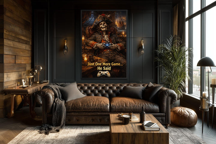 A framed canvas print of a pirate skeleton gaming, titled Just One More Game, in a dark living room.