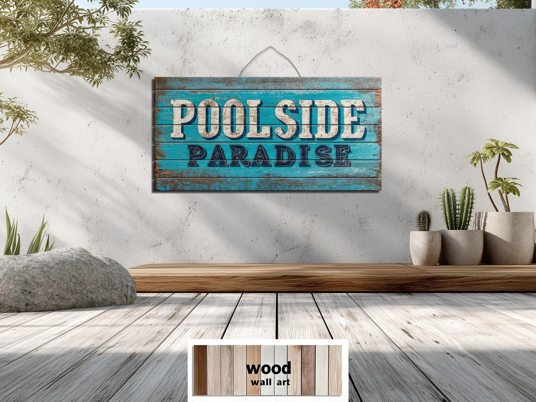 A rustic wood wall art sign with Poolside Paradise text hangs on a textured outdoor wall.