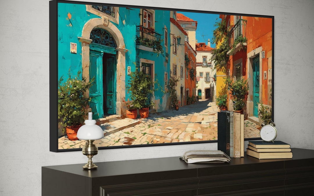 Vibrant Portugal street scene framed canvas wall art above a dark wood dresser with decor.