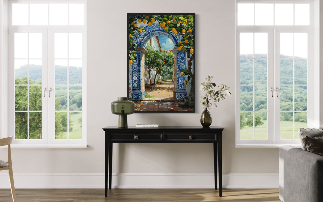 Portuguese doorway wall art with blue azulejos tiles and orange trees above a black console table.