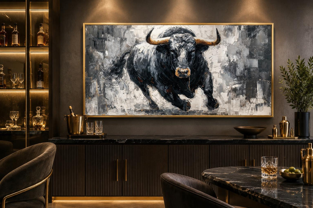 Large framed canvas wall art of a charging black bull in a modern office or lounge setting.