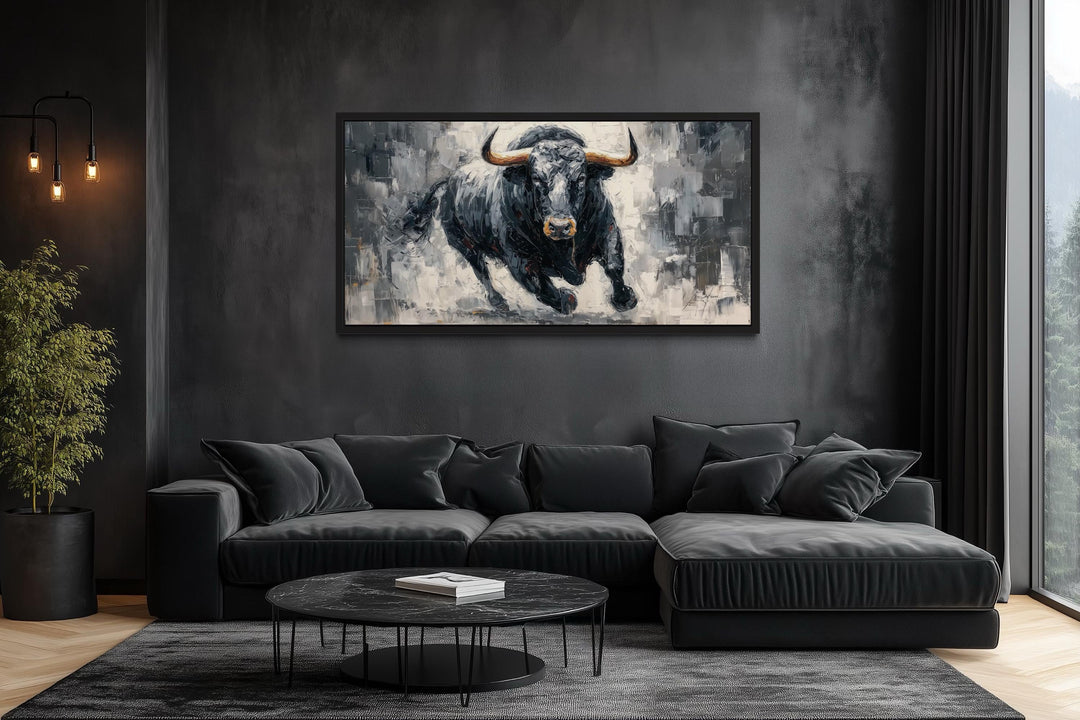 Powerful charging black bull canvas wall art in a modern dark-themed office or living room.