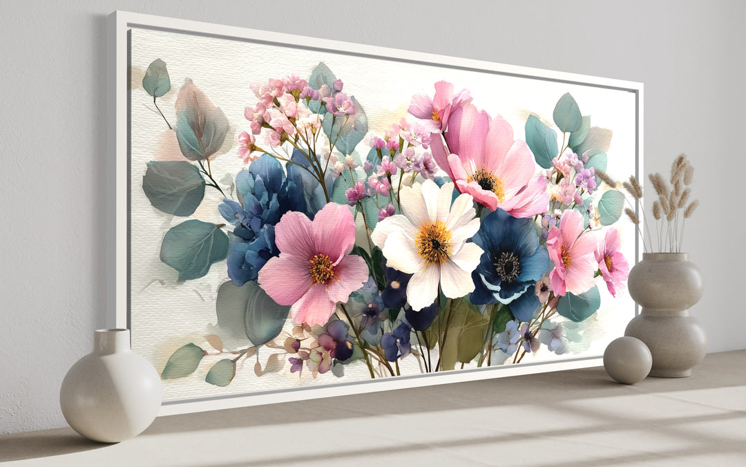 Pretty blue and pink wildflower bouquet framed canvas wall art in a horizontal white frame.