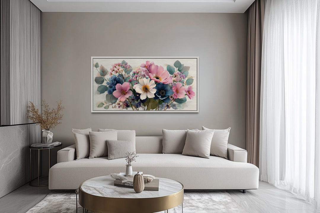 Pretty blue and pink wildflowers bouquet framed canvas wall art hanging above a modern sofa.