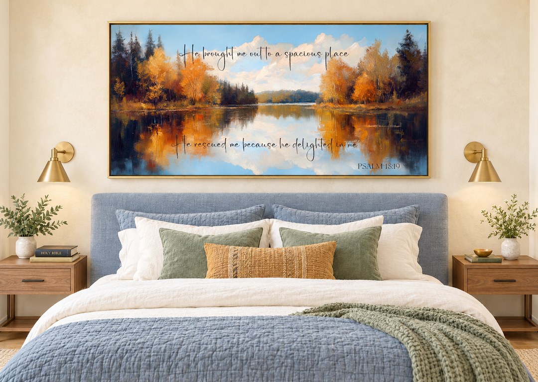 Psalm 18:19 canvas art featuring an autumn lake painting above a blue bed in a modern bedroom.