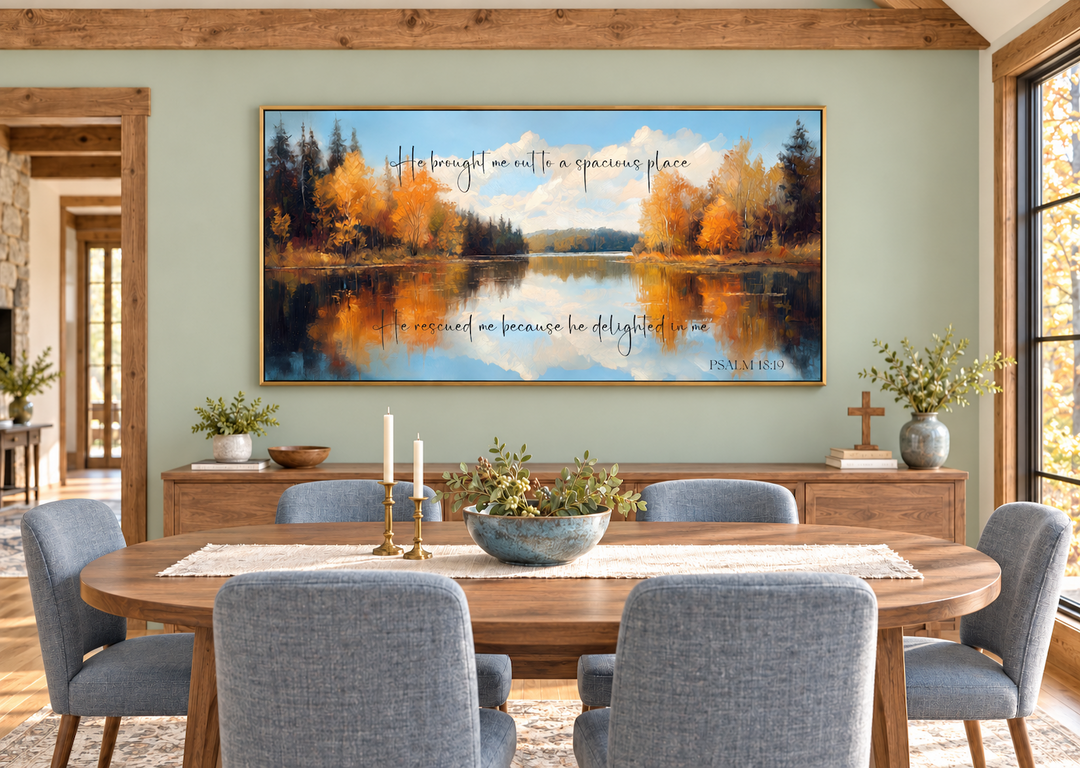 Psalm 18:19 canvas art featuring an autumn lake painting above a dining table in a rustic room.