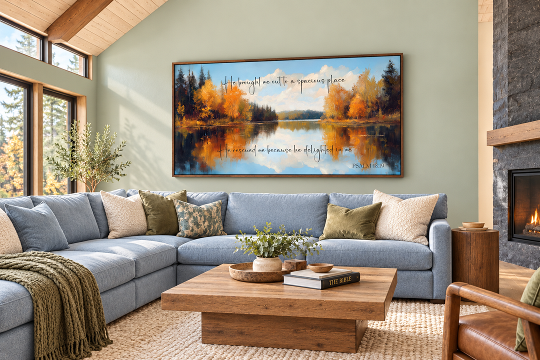 Psalm 18:19 canvas art featuring an autumn lake painting above a blue sectional sofa.