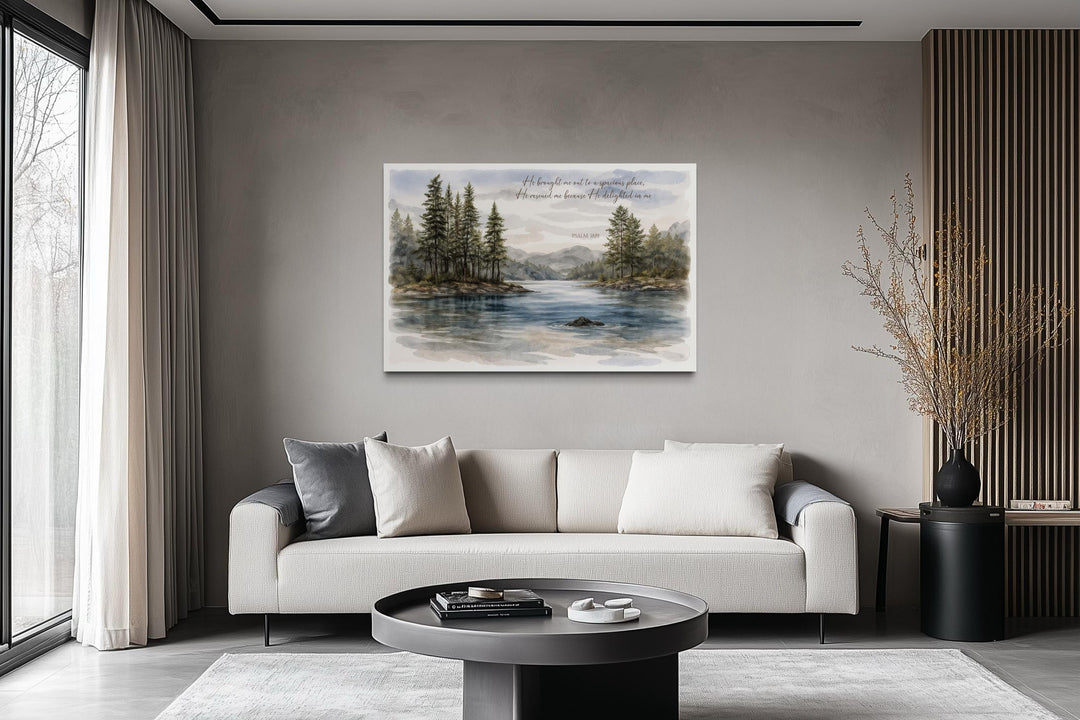 A serene lake landscape canvas print with Psalm 18:19 scripture hangs above a modern sofa.
